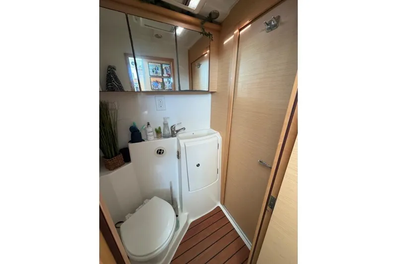 Slide: The Image of Compact bathroom in a 2008 Lagoon 420 yacht with wooden flooring and modern fixtures. - 25