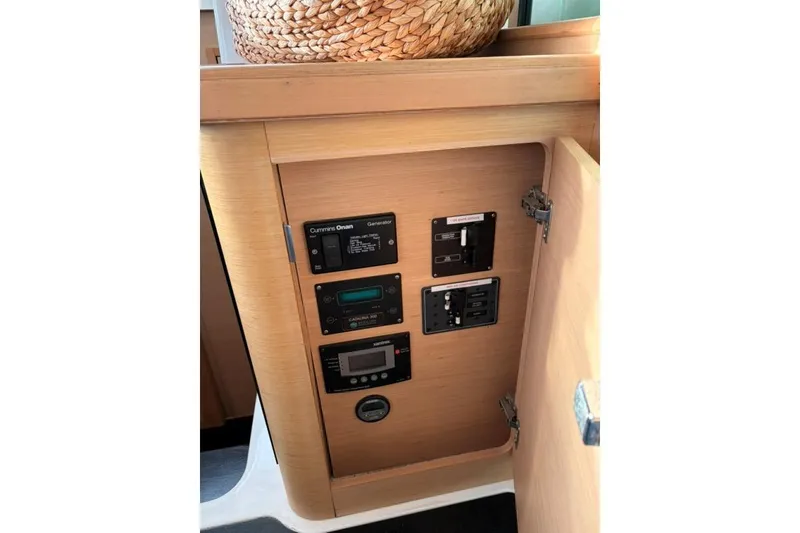 Slide: The Image of Control panel inside 2008 Lagoon 420 yacht, featuring various switches and displays. - 28
