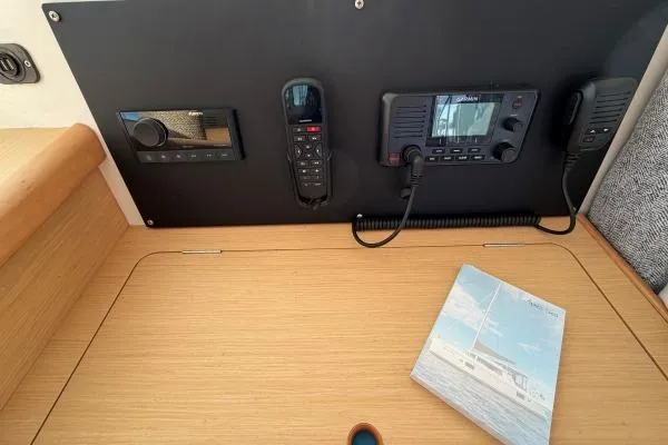 Slide: The Image of Control panel of a 2008 Lagoon 420 yacht with communication devices and a manual. - 30