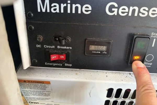 Slide: The Image of Control panel of a 2008 Lagoon 420 marine generator with circuit breakers and hour meter. - 31