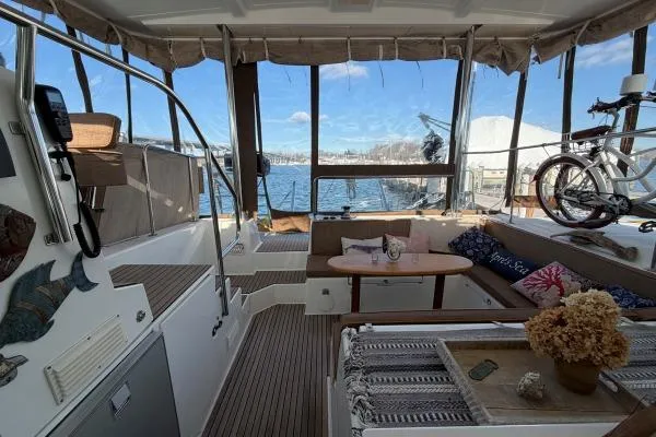 Slide: The Image of Interior of 2008 Lagoon 420 yacht with cozy seating and scenic marina view. - 36