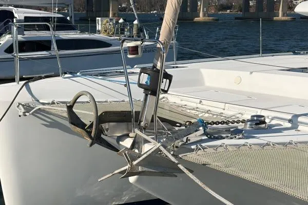 Slide: The Image of Bow of 2008 Lagoon 420 catamaran with anchor and netting, docked in marina. - 41