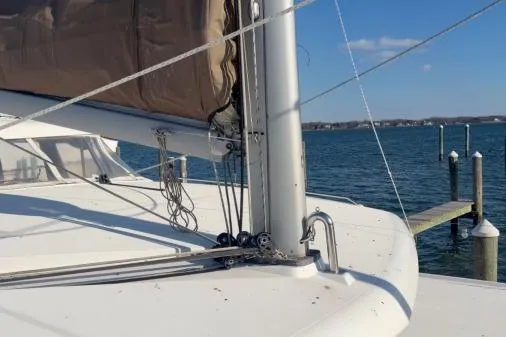 Slide: The Image of 2008 Lagoon 420 sailboat deck with mast and rigging, docked by calm waters. - 42