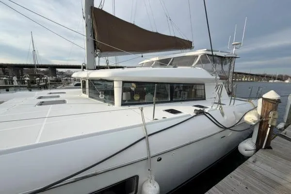 Slide: The Image of 2008 Lagoon 420 catamaran docked at marina, featuring sleek design and spacious deck. - 45