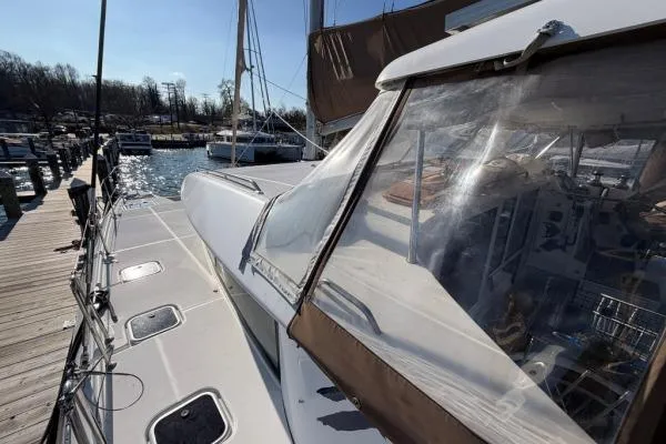 Slide: The Image of 2008 Lagoon 420 catamaran docked, showcasing deck and cockpit area under clear skies. - 47