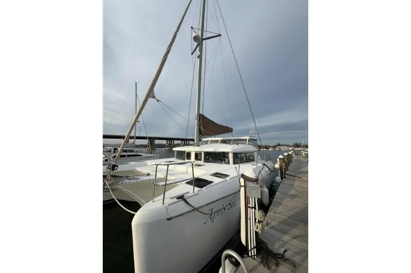 Slide: The Image of 2008 Lagoon 420 catamaran docked at marina under cloudy sky. - 50