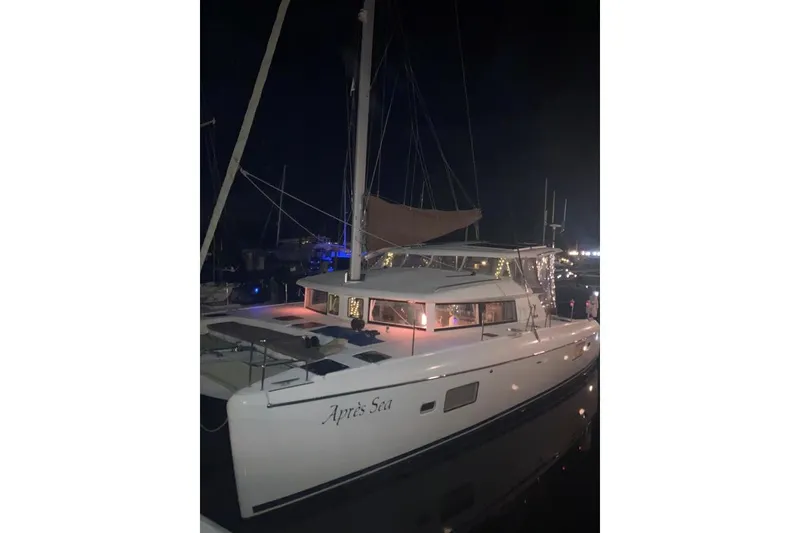 Slide: The Image of 2008 Lagoon 420 catamaran docked at night with illuminated interior. - 53
