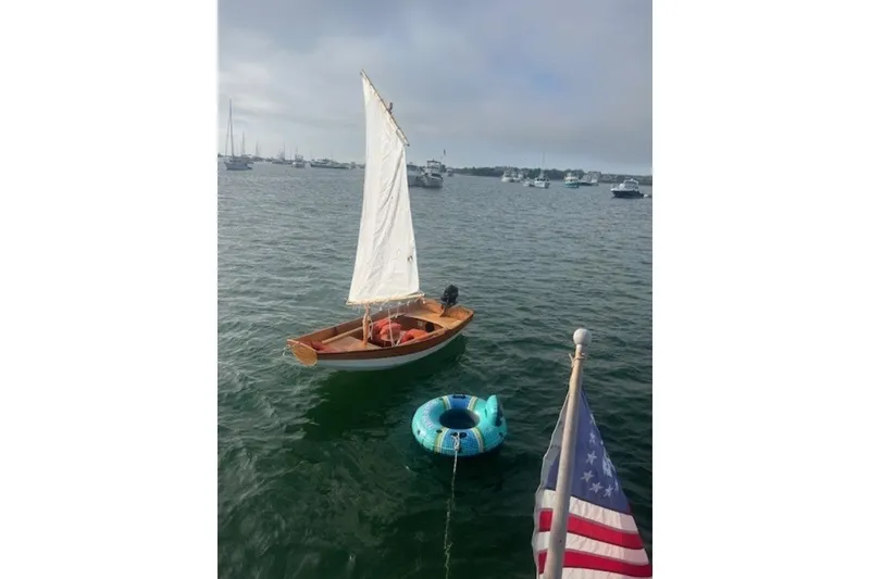Slide: The Image of Small sailboat on water near inflatable tube and American flag, Lagoon 420, 2008. - 57