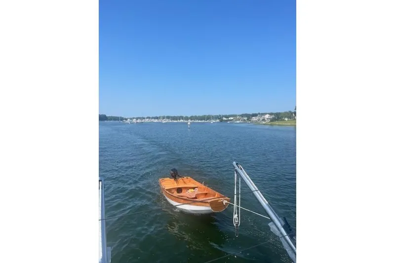 Slide: The Image of Sailboat on calm water, view from Lagoon 420, 2008 model, under clear blue sky. - 58