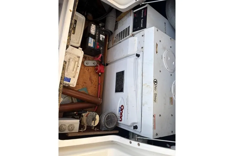 Slide: The Image of Engine compartment of a 2008 Lagoon 420 catamaran with Onan generator and battery. - 60