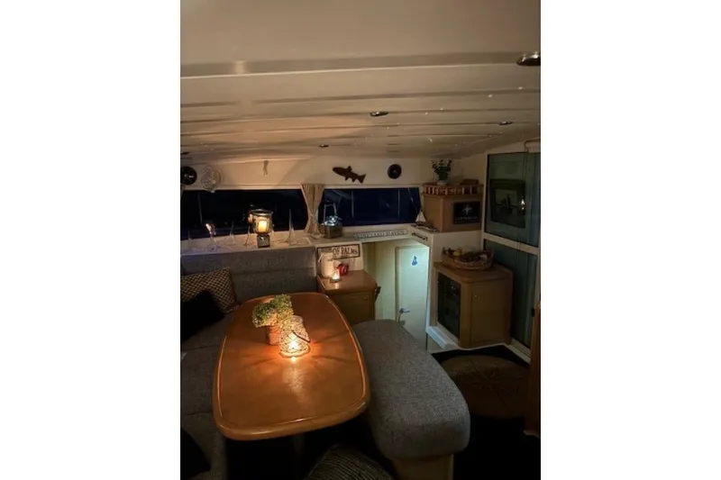 Slide: The Image of Cozy interior of a 2008 Lagoon 420 catamaran with ambient lighting and decor. - 8