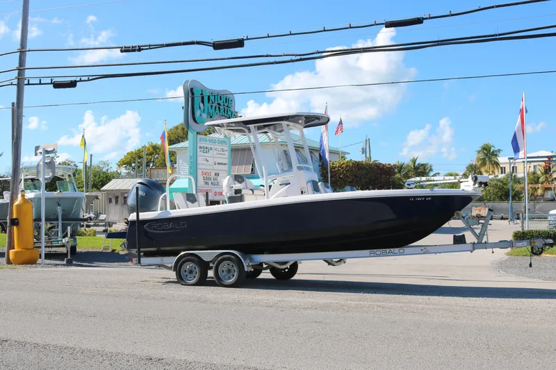 Slide: The Image of 2024 Robalo 226 Cayman boat on trailer at Unique Marine dealership. - 1