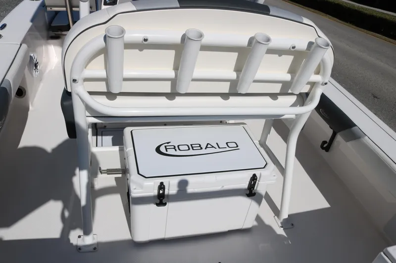 Slide: The Image of 2024 Robalo 226 Cayman boat interior with rod holders and branded cooler. - 10