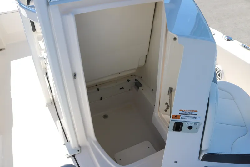 Slide: The Image of 2024 Robalo 226 Cayman boat storage compartment with open hatch, showcasing interior space. - 11