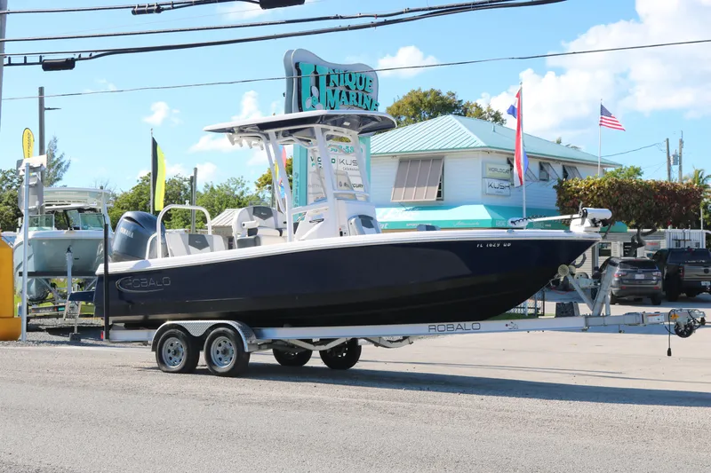 Slide: The Image of 2024 Robalo 226 Cayman boat on trailer at Unique Marine dealership. - 3