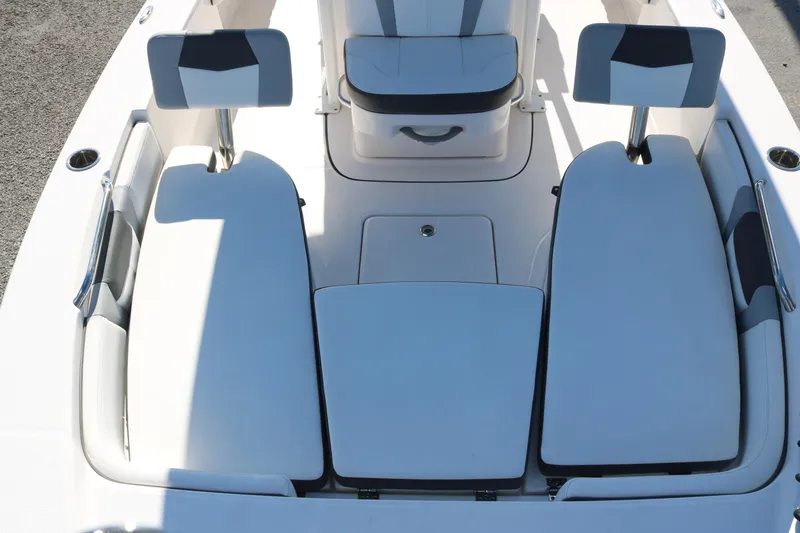 Slide: The Image of 2024 Robalo 226 Cayman boat interior with cushioned seating and storage compartments. - 6