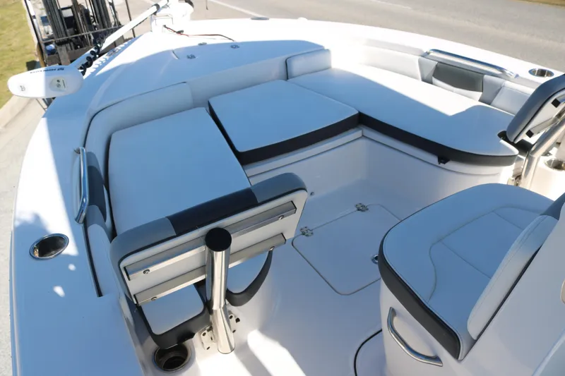 Slide: The Image of 2024 Robalo 226 Cayman boat interior with cushioned seating and storage compartments. - 7