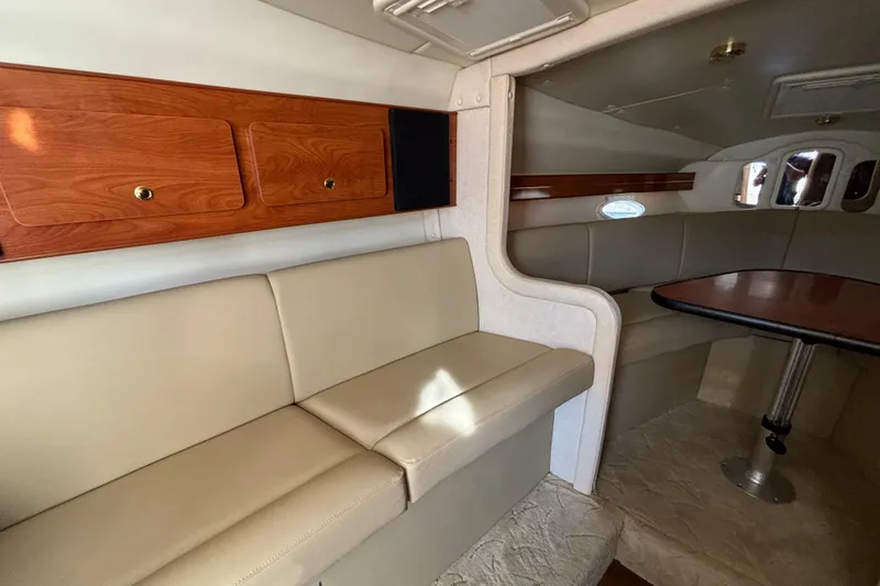 Slide: The Image of 2005 Rinker Fiesta Vee 300 boat docked in marina with waterfront buildings. - 10