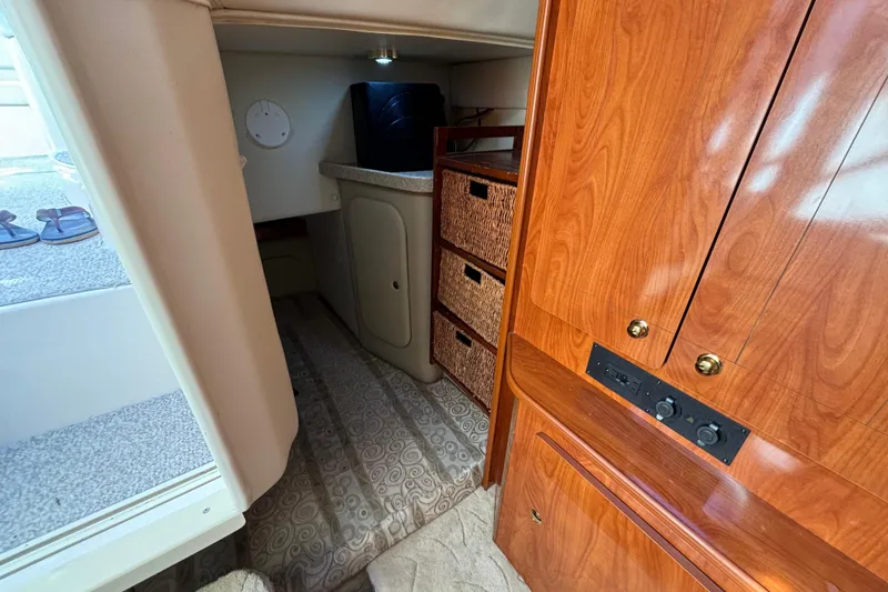 Slide: The Image of 2005 Rinker Fiesta Vee 300 cabin interior with seating and table. - 11