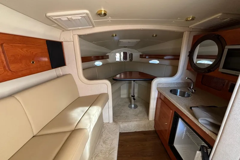 Slide: The Image of 2005 Rinker Fiesta Vee 300 interior with kitchenette and dining area. - 12