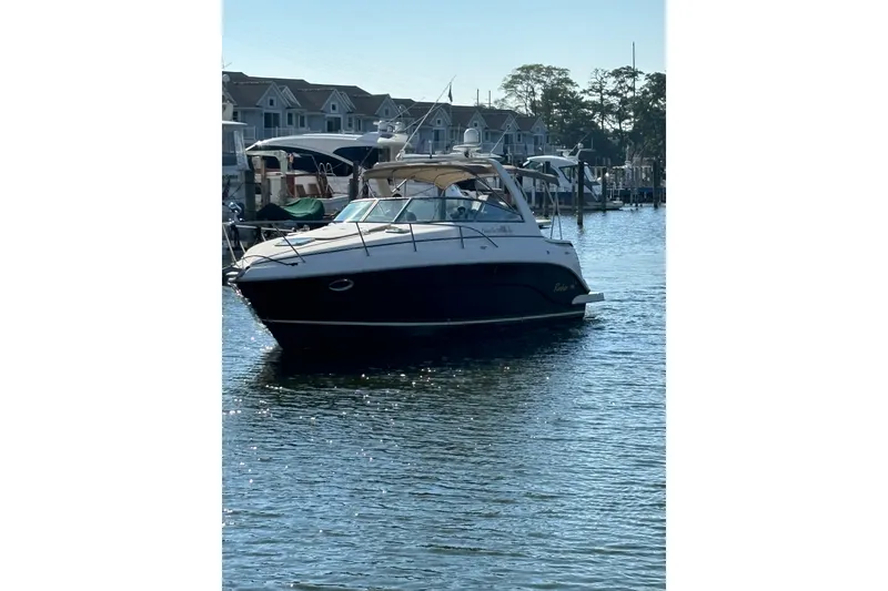 Slide: The Image of 2005 Rinker Fiesta Vee 300 boat in indoor storage, elevated on stands. - 5