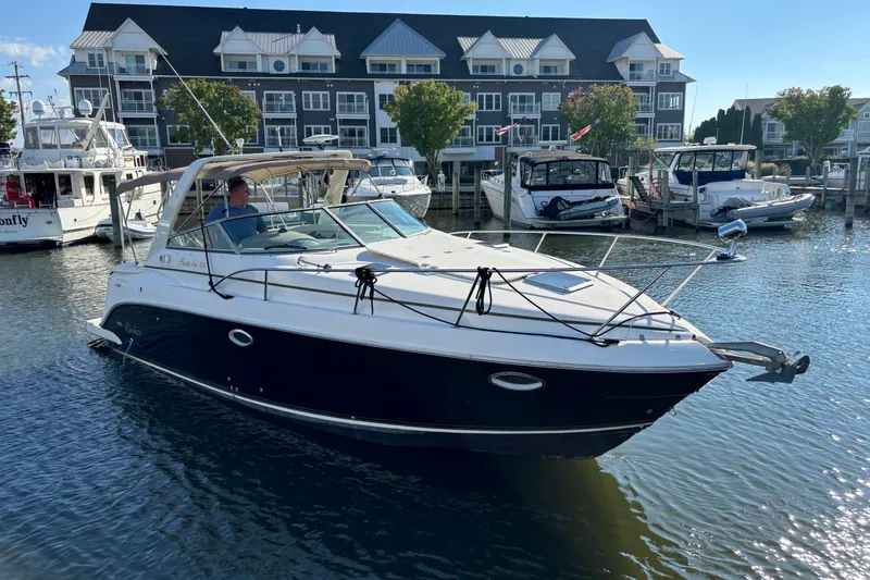 Slide: The Image of 2005 Rinker Fiesta Vee 300 boat docked at marina under blue sky. - 6