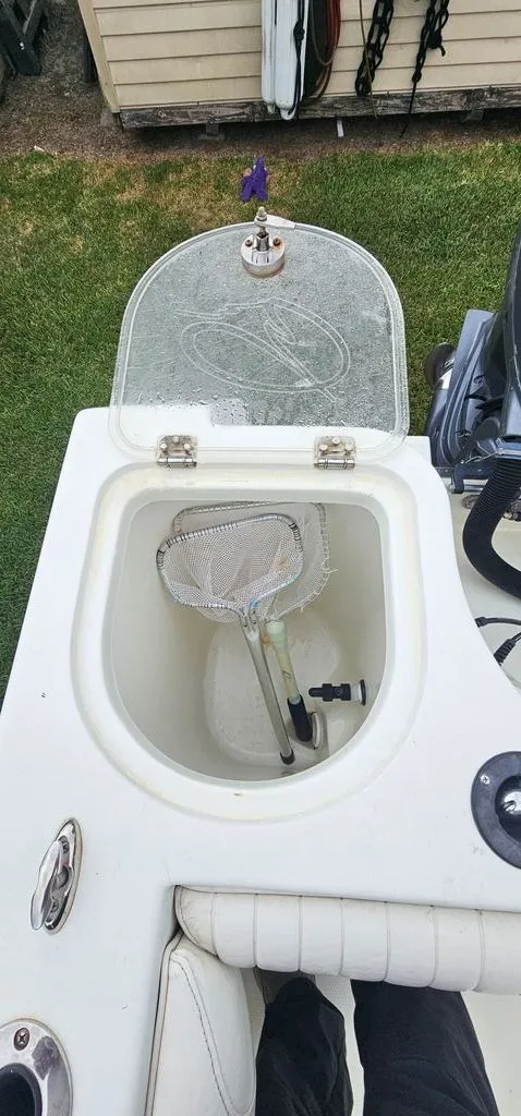 Slide: The Image of Sailfish 2360 CC 2008 boat with open storage compartment and net. - 18