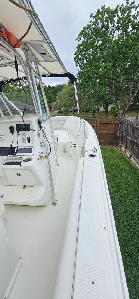 Slide: The Image of 2008 Sailfish 2360 CC boat parked in a garden. - 21