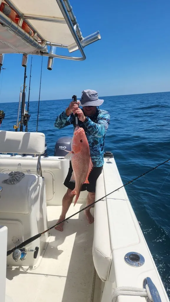 Slide: The Image of Angler holding large fish on Sailfish 2360 CC boat, 2008 model. - 24