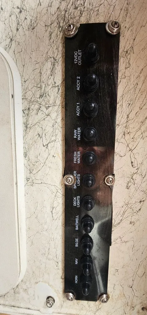 Slide: The Image of Control panel of a 2008 Sailfish 2360 CC boat with various switches. - 30