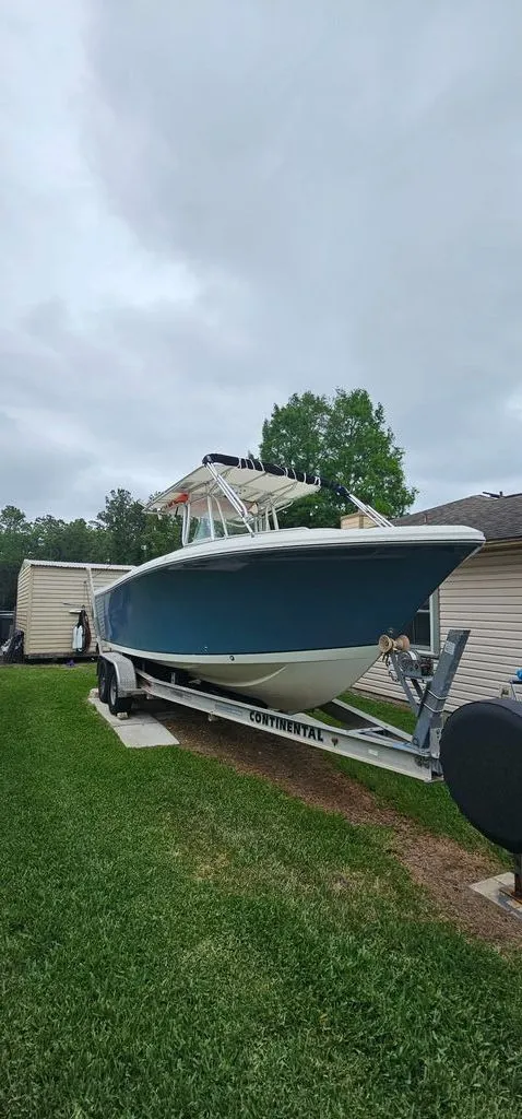 Slide: The Image of 2008 Sailfish 2360 CC boat on trailer in yard. - 31