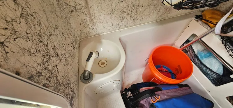 Slide: The Image of Interior of 2008 Sailfish 2360 CC with sink and bucket. - 40