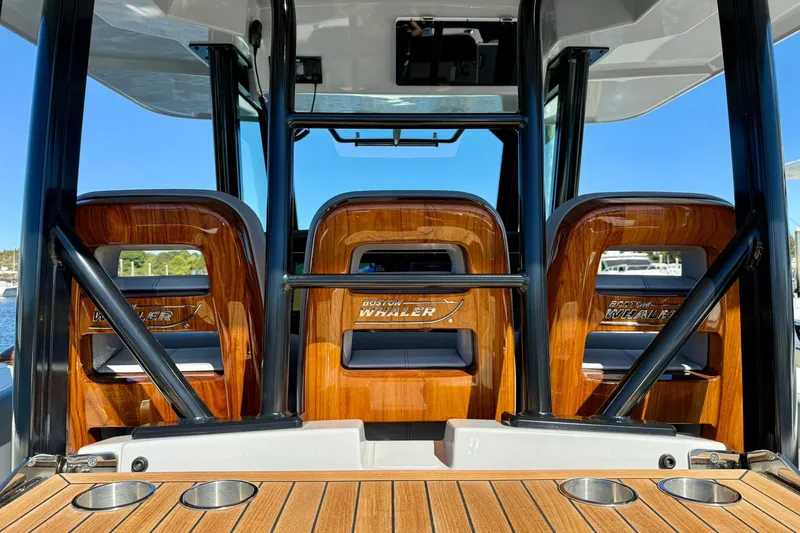 Slide: The Image of 2024 Boston Whaler 360 Outrage interior with polished wood accents and sturdy metal supports. - 14