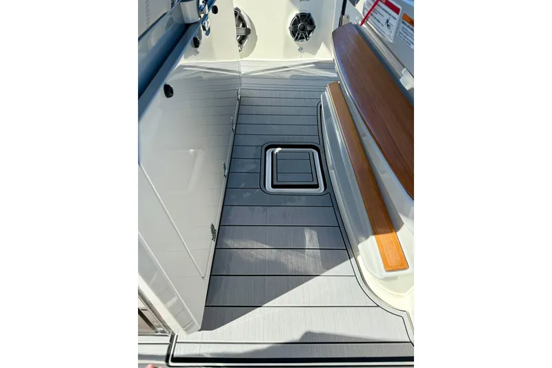 Slide: The Image of 2024 Boston Whaler 360 Outrage interior with sleek flooring and wood accents. - 20
