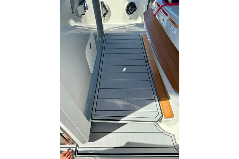 Slide: The Image of 2024 Boston Whaler 360 Outrage deck with sleek flooring and modern design elements. - 21