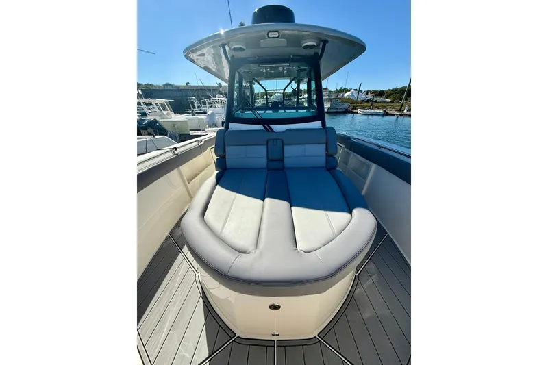 Slide: The Image of 2024 Boston Whaler 360 Outrage boat interior with cushioned seating and sleek design. - 23