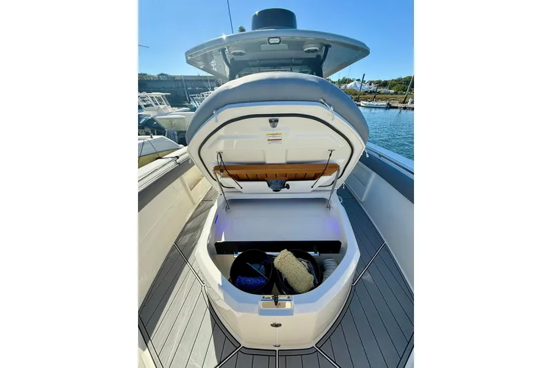 Slide: The Image of 2024 Boston Whaler 360 Outrage boat storage compartment open at marina. - 24