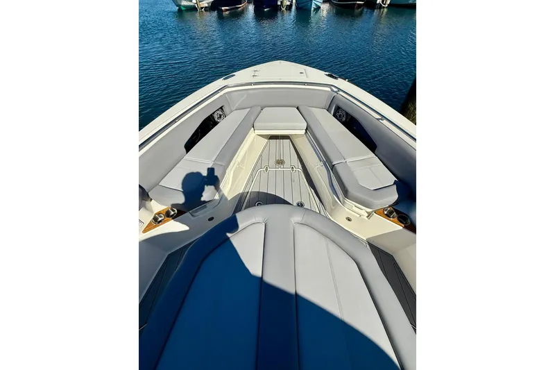 Slide: The Image of 2024 Boston Whaler 360 Outrage boat interior with cushioned seating and sleek design. - 27