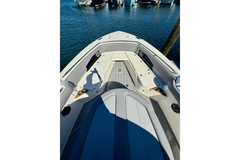 Slide: The Image of 2024 Boston Whaler 360 Outrage boat interior with seating and deck view. - 28