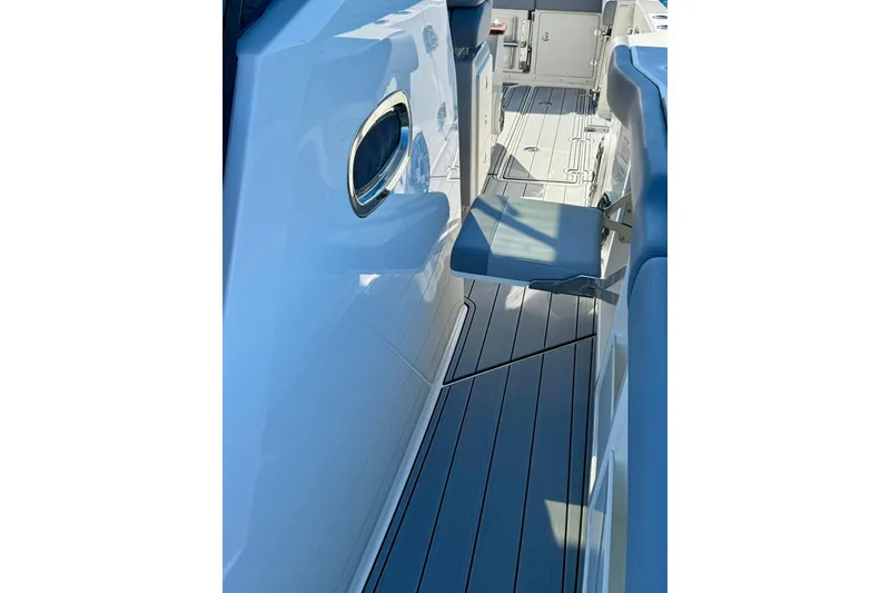 Slide: The Image of 2024 Boston Whaler 360 Outrage boat interior with sleek seating and modern design. - 30