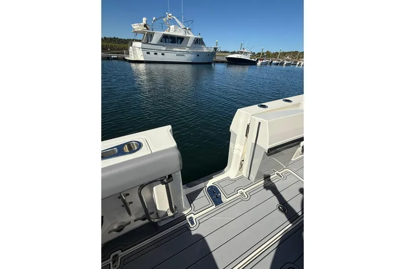 Slide: The Image of 2024 Boston Whaler 360 Outrage boat deck with marina view in the background. - 33