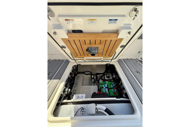 Slide: The Image of 2024 Boston Whaler 360 Outrage engine compartment with visible components and wiring. - 36