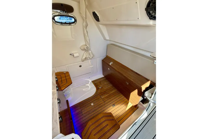 Slide: The Image of 2024 Boston Whaler 360 Outrage cabin interior with wood flooring and modern design. - 41