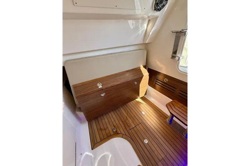 Slide: The Image of 2024 Boston Whaler 360 Outrage interior with elegant wood flooring and seating. - 42