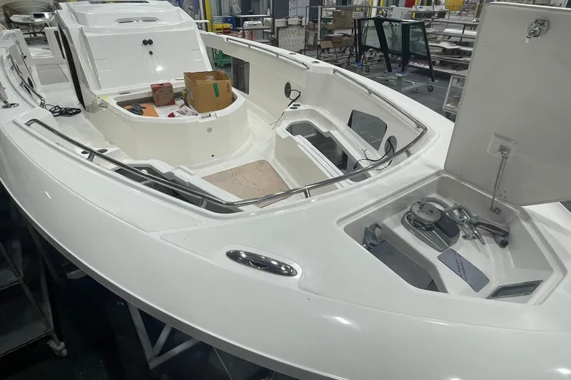 Slide: The Image of 2024 Boston Whaler 360 Outrage boat interior under construction in a workshop. - 50
