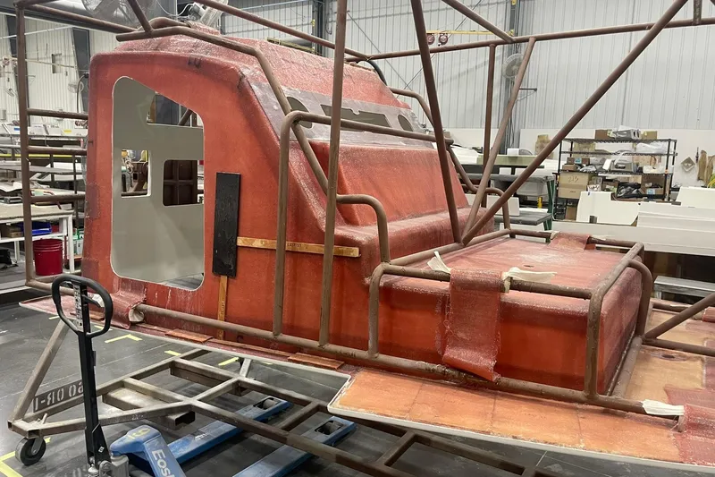 Slide: The Image of 2024 Boston Whaler 360 Outrage under construction in a workshop. - 51