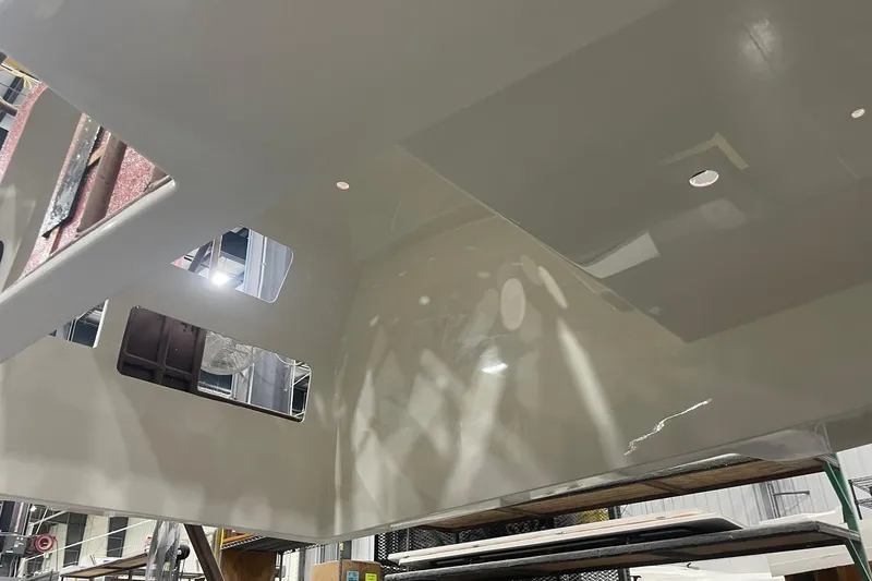 Slide: The Image of 2024 Boston Whaler 360 Outrage under construction, showcasing interior framework details. - 52