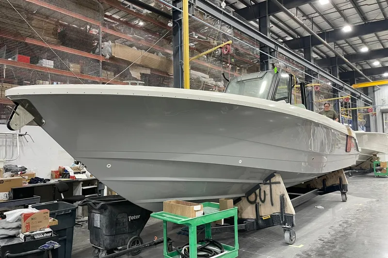 Slide: The Image of 2024 Boston Whaler 360 Outrage boat in a manufacturing facility. - 54