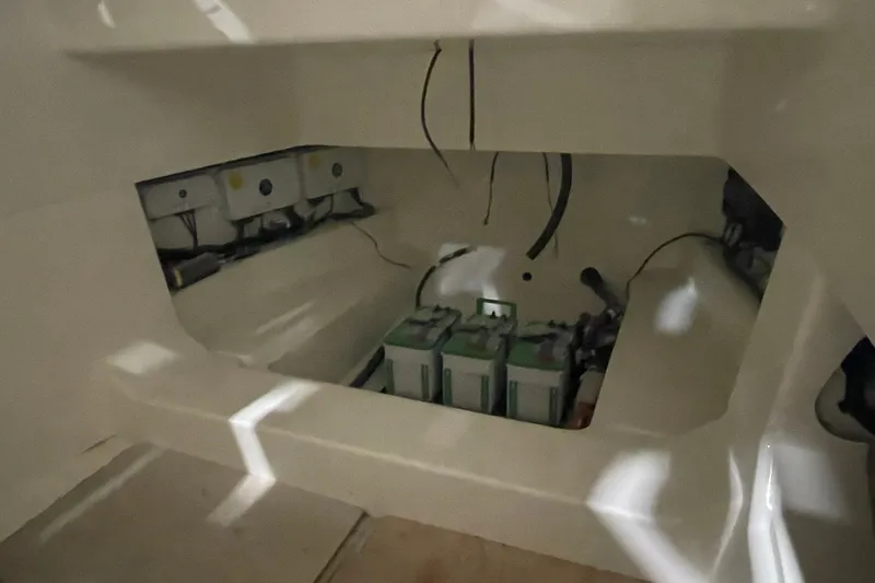 Slide: The Image of 2024 Boston Whaler 360 Outrage battery compartment with wiring and equipment. - 59