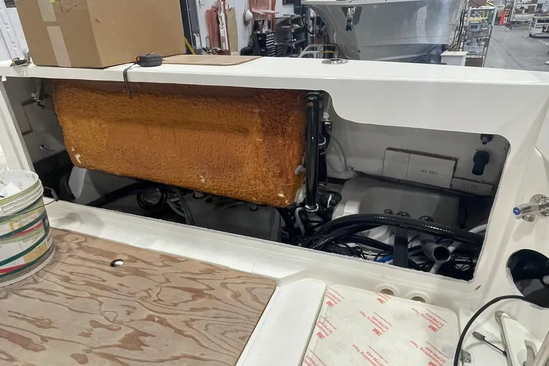 Slide: The Image of 2024 Boston Whaler 360 Outrage engine compartment with visible components and wiring. - 63